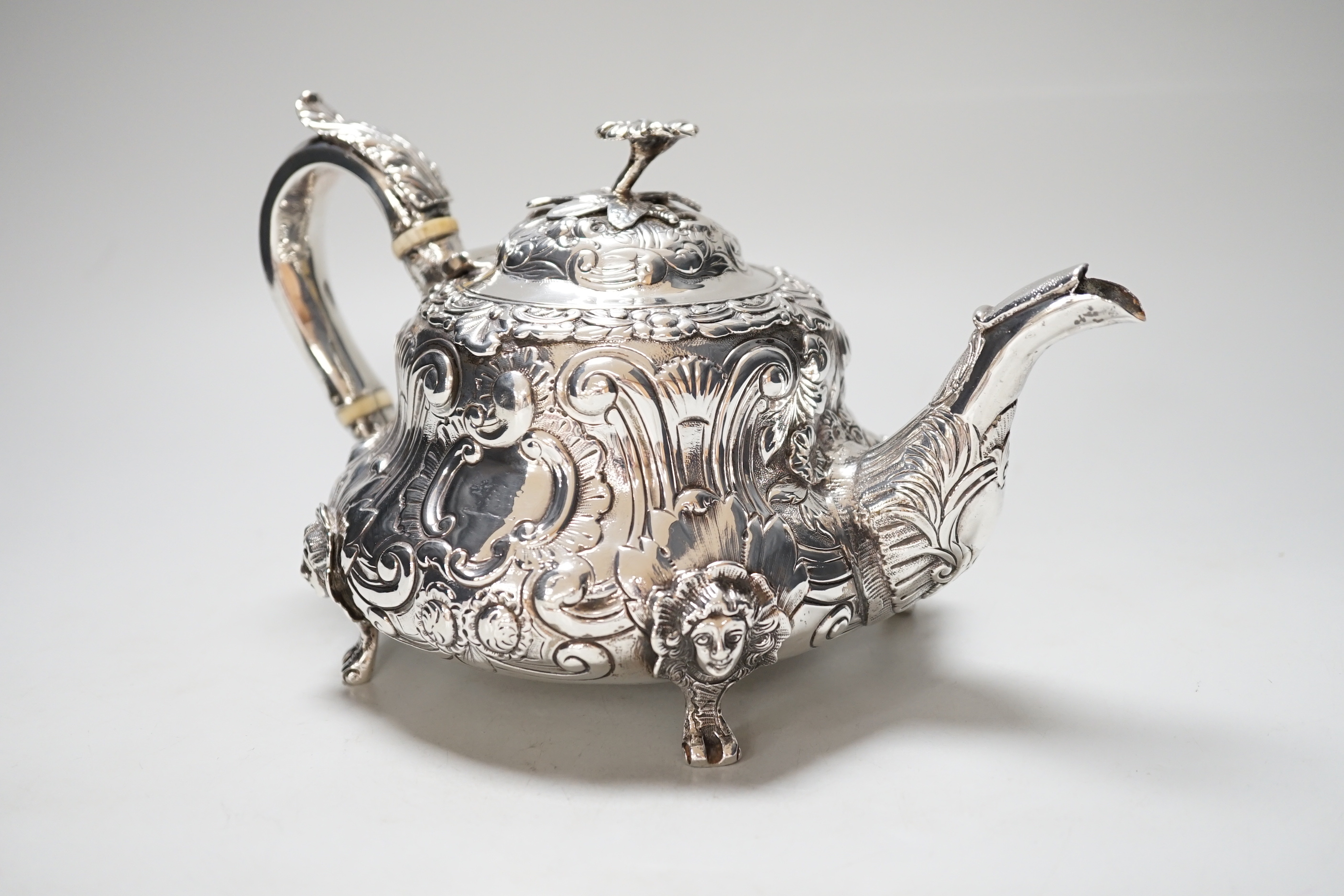 A William IV silver teapot, with floral knop, scroll and mask decoration, makers mark rubbed, London 1831, gross 617 grams, CITIES Submission reference NX44TQHA